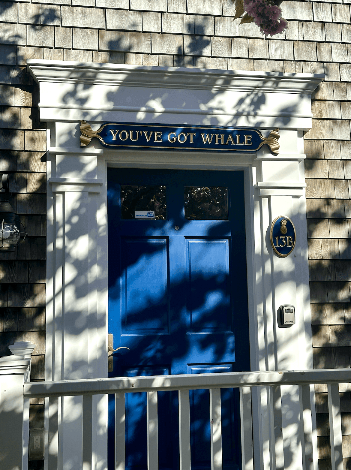 You've Got Whale quarterboard and house number 13B over the blue front door