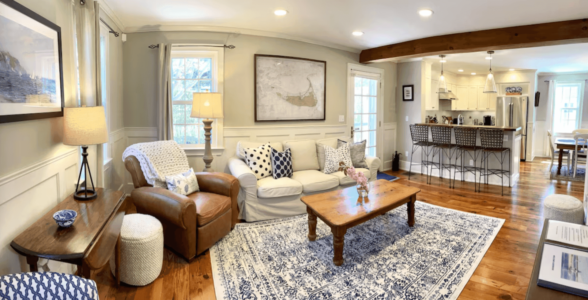 Open living room with a Nantucket map and cream sofa