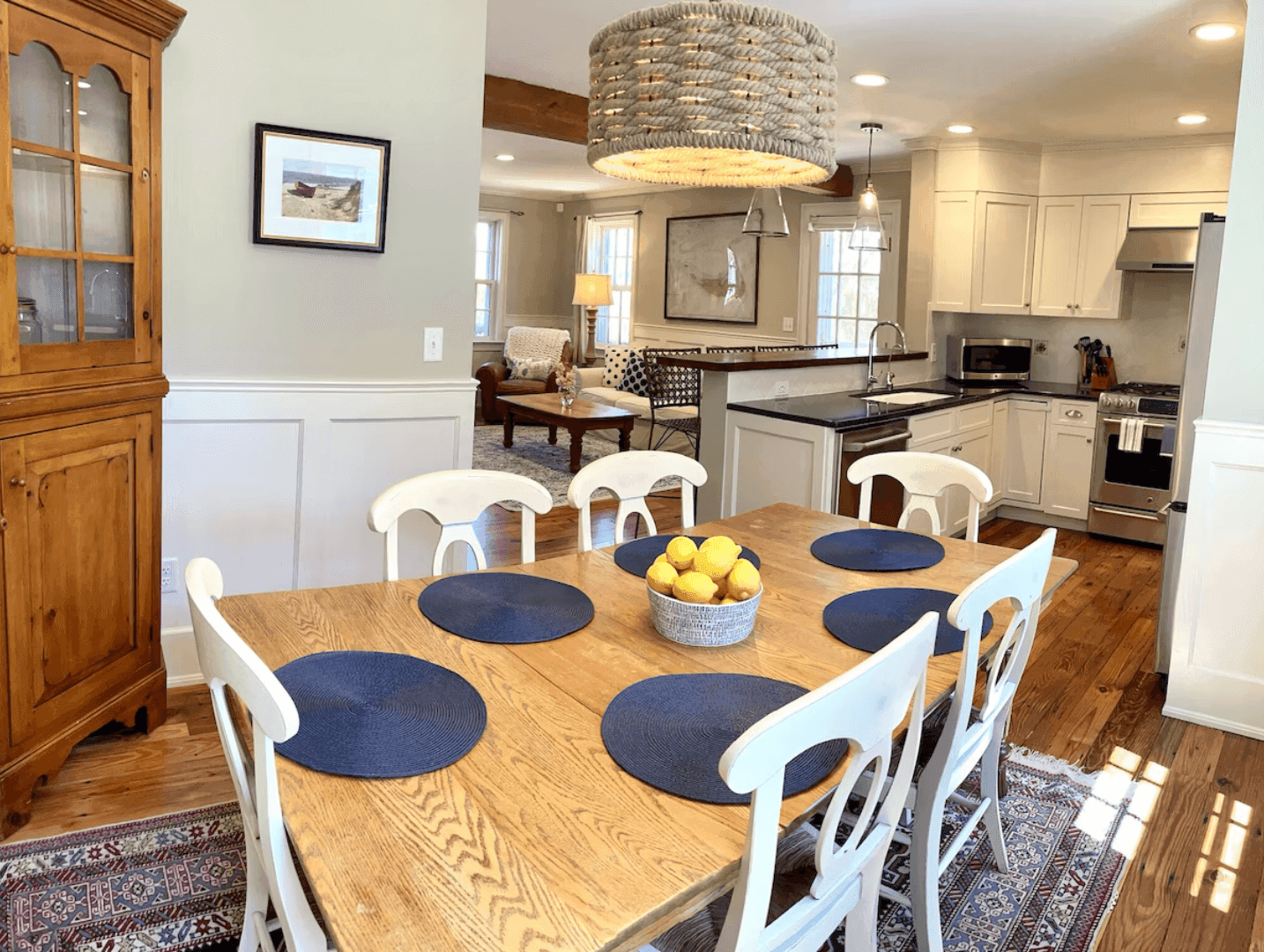 Dining table set with navy placemats and a bowl of lemons