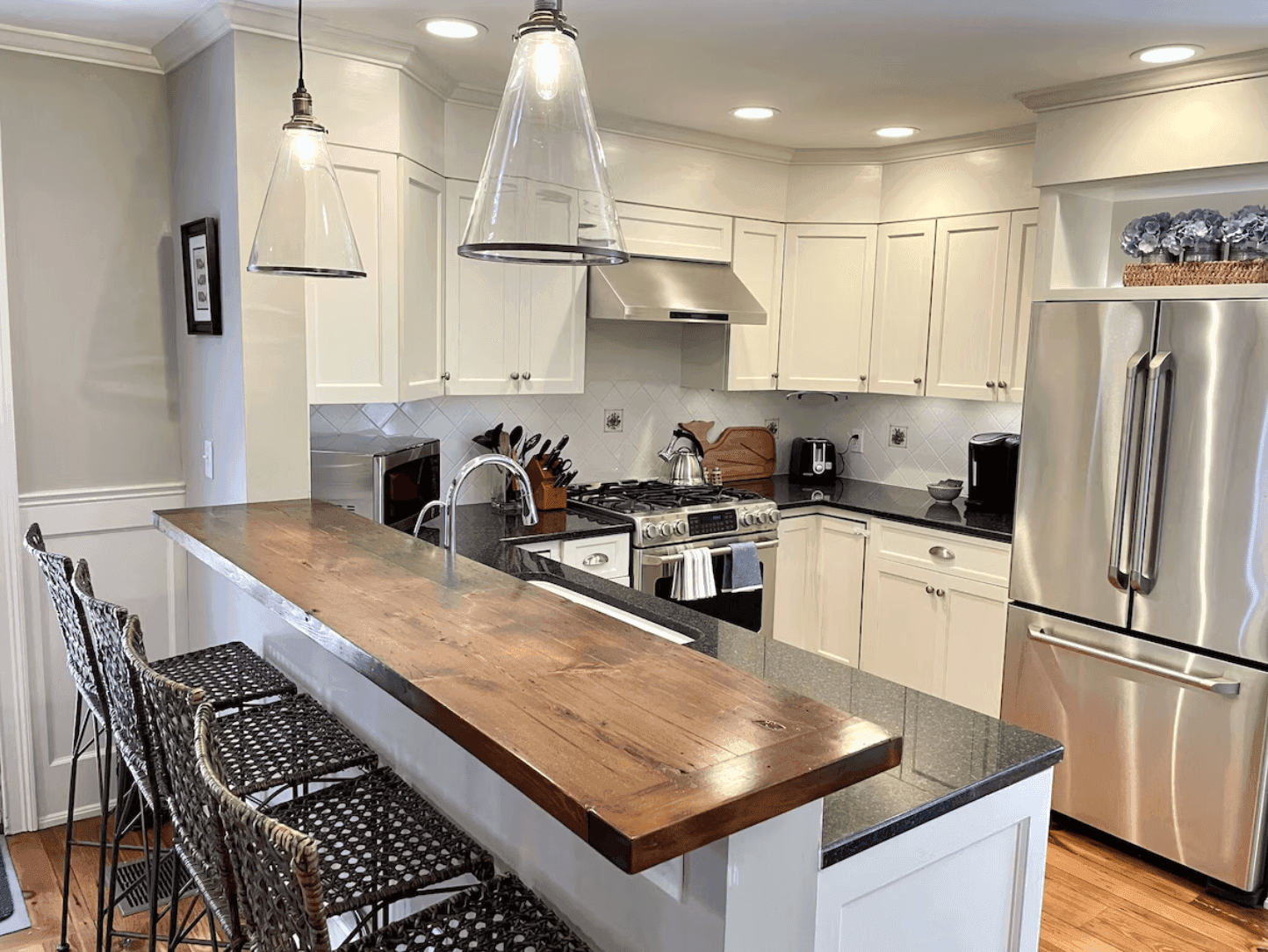 Kitchen with a wooden breakfast bar and four stools