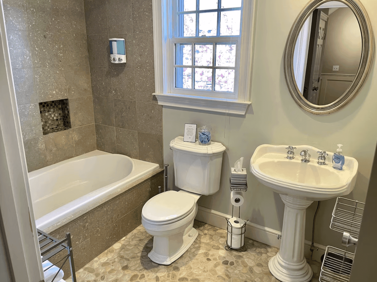Bathroom with a soaking tub and pebble floor